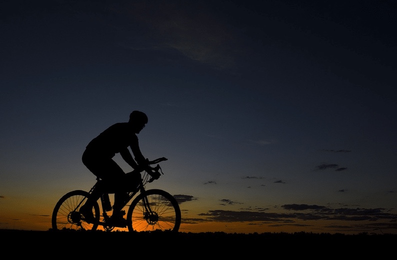 Someone cycling at sunrise