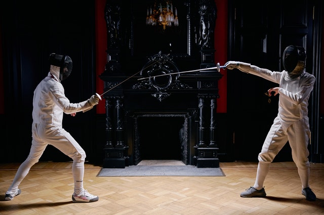 Two fencers preparing to attack